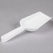 A Fineline white plastic utility and ice scoop.