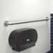 A Lavex metal grab bar with a peened grip on a white wall.