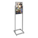 A chrome rectangular tube stand pedestal with a display board of pictures on it.