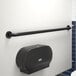 A white wall with a Lavex 48" restroom grab bar with a matte black finish.