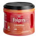 A plastic Folgers Colombian Ground Coffee can with a black lid on a counter.