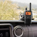 A Midland X-TALKER walkie talkie set on a car dashboard.