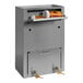 A stainless steel Omnimed medication drop box with key locks on a shelf.