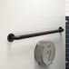 A Lavex matte black grab bar on a white wall.
