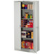 A Tennsco light gray metal storage cabinet with shelves and many boxes on the shelves.