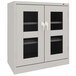 A light gray Tennsco storage cabinet with C-Thru doors and a handle.