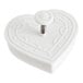 A white heart-shaped plastic cutter with a metal spring.