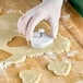 A person using an Ateco heart shaped plunger cutter to cut out cookies.