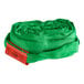 A green fabric roll of Lift-All Tuflex roundsling with a red tag.