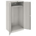A light gray Tennsco metal cabinet with open doors.