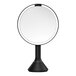 A circular mirror with a black border.