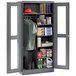 A dark gray Tennsco metal combination cabinet with open doors.