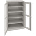 A light gray Tennsco storage cabinet with open doors.