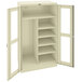 A putty metal Tennsco combination cabinet with open doors.