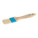 An Ateco baking and pastry brush with a wood handle and blue bristles.