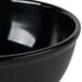 A close-up of a black Cal-Mil melamine bowl.