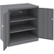 A dark gray Tennsco steel storage cabinet with open doors.