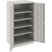 A light gray metal Tennsco storage cabinet with solid doors.