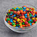 A bowl of M&M's on a table.