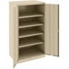 A tan metal Tennsco storage cabinet with open doors.