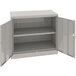 A light gray metal Tennsco storage cabinet with open doors.