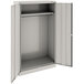 A light gray metal Tennsco wardrobe cabinet with open solid doors.