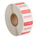 A roll of white labels with red text reading "Wednesday" and "Noble Products"