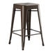 A brown metal Lancaster Table & Seating outdoor backless counter height stool with legs.