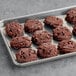 Preformed chocolate chip cookies from Root Nine Baking Co. on a baking sheet.