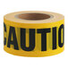 A roll of yellow Xpose Safety "Caution" tape with black text.