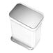 A white simplehuman rectangular step-on trash can with a silver lid.