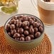 A bowl of Capora milk chocolate covered espresso beans.