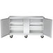 A stainless steel Traulsen undercounter freezer with left and right hinged doors open.