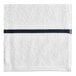 A white pool towel with navy blue stripes.