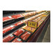 A display of meat on a black Borray meat shelf liner in a store.