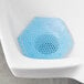 A blue mesh mat in a urinal.