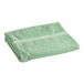 A folded Oxford Imperiale Kashmir Green pool towel.