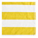 A close-up of a yellow and white striped fabric towel.