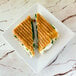 A sandwich on a 10 Strawberry Street Whittier white square porcelain plate.