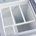 An Avantco white gelato dipping cabinet with a drawer open.