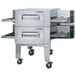 A Lincoln Impinger conveyor oven with wheels and the lid open.