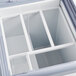 An Avantco gelato dipping cabinet with a curved sneeze guard and pans on a white background.