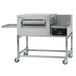 A stainless steel Lincoln Impinger conveyor oven on wheels with a window.