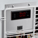 The thermostat control panel with a digital display on a white Avantco countertop display freezer.