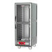 A Metro C5 gray heated holding cabinet with clear Dutch doors on wheels.
