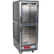 A large grey Metro C5 heated holding cabinet with clear Dutch doors.