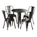 A Lancaster Table & Seating distressed copper table with four black metal chairs.
