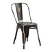A black metal Lancaster Table & Seating chair with a black seat on a Lancaster Table & Seating outdoor table.