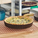 A quiche in a Gobel round fluted deep tart pan with removable bottom.