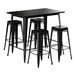 A Lancaster Table & Seating black bar height table with four black barstools.